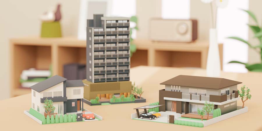 戸建て・マンション・大型住宅の模型が並んだ構図